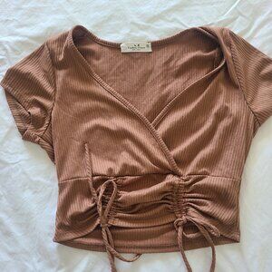 Cropped top with ties in the front.  Nice cleavage.